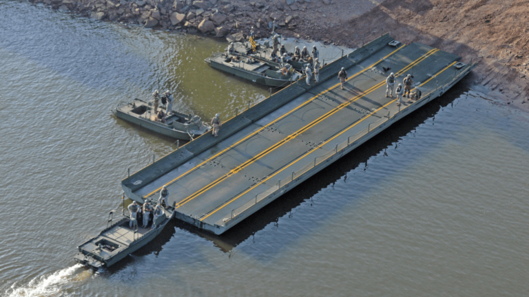MKII Bridge Erection Boats position three Improved Ribbon Bridge (IRB) Bay Sections on the shore of the Arkansas River during River Assault 2017 on Fort Chaffee Manuever Training Center