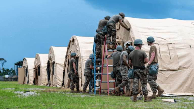 U.S. Airmen cover temporary shelters during a bare base construction capstone event